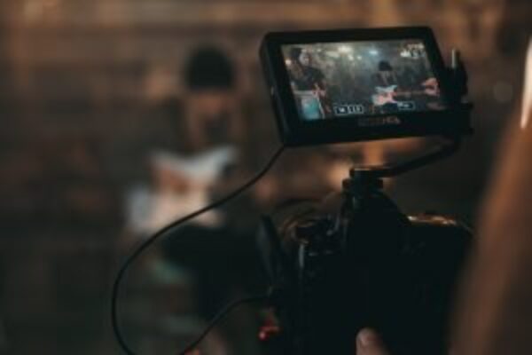 Digital camera on set capturing a behind-the-scenes look at a video production.