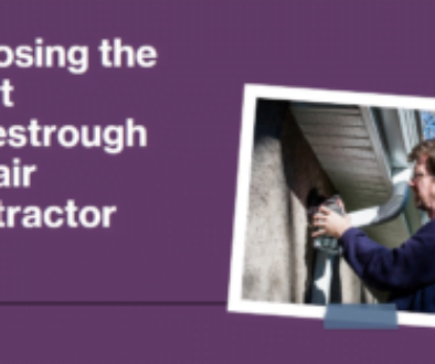 A person repairing an eavestrough on a house.